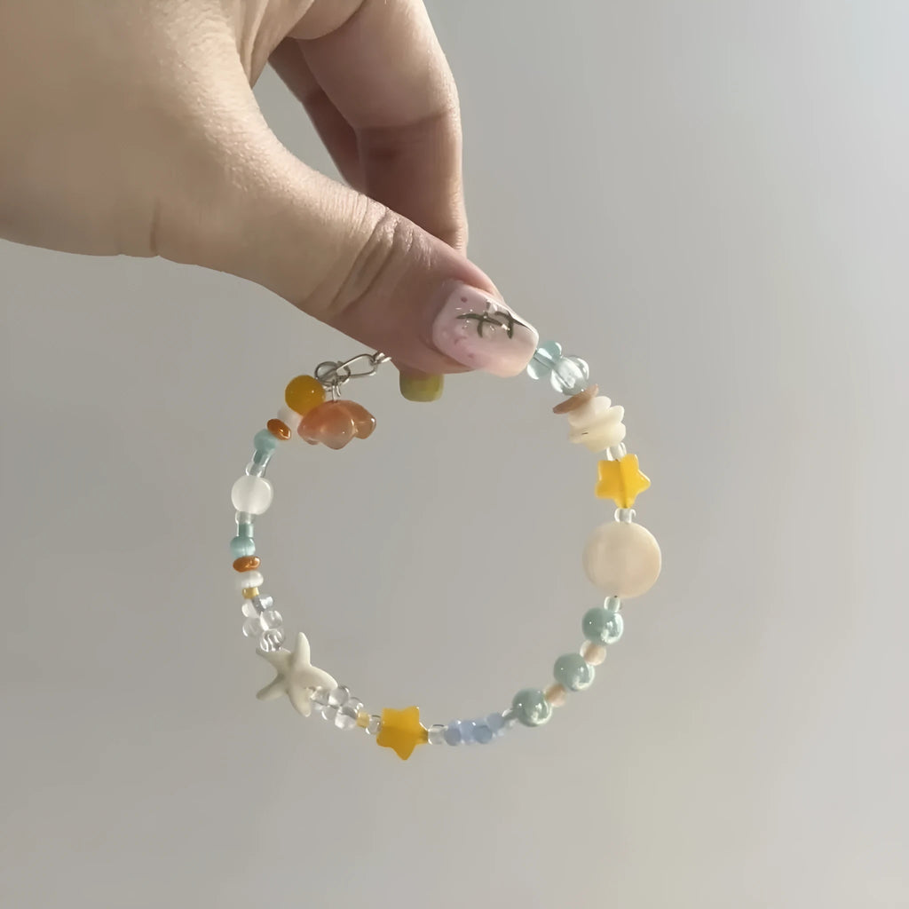 Orange and sea tone mixed material bracelet with diamond shapes and round elements