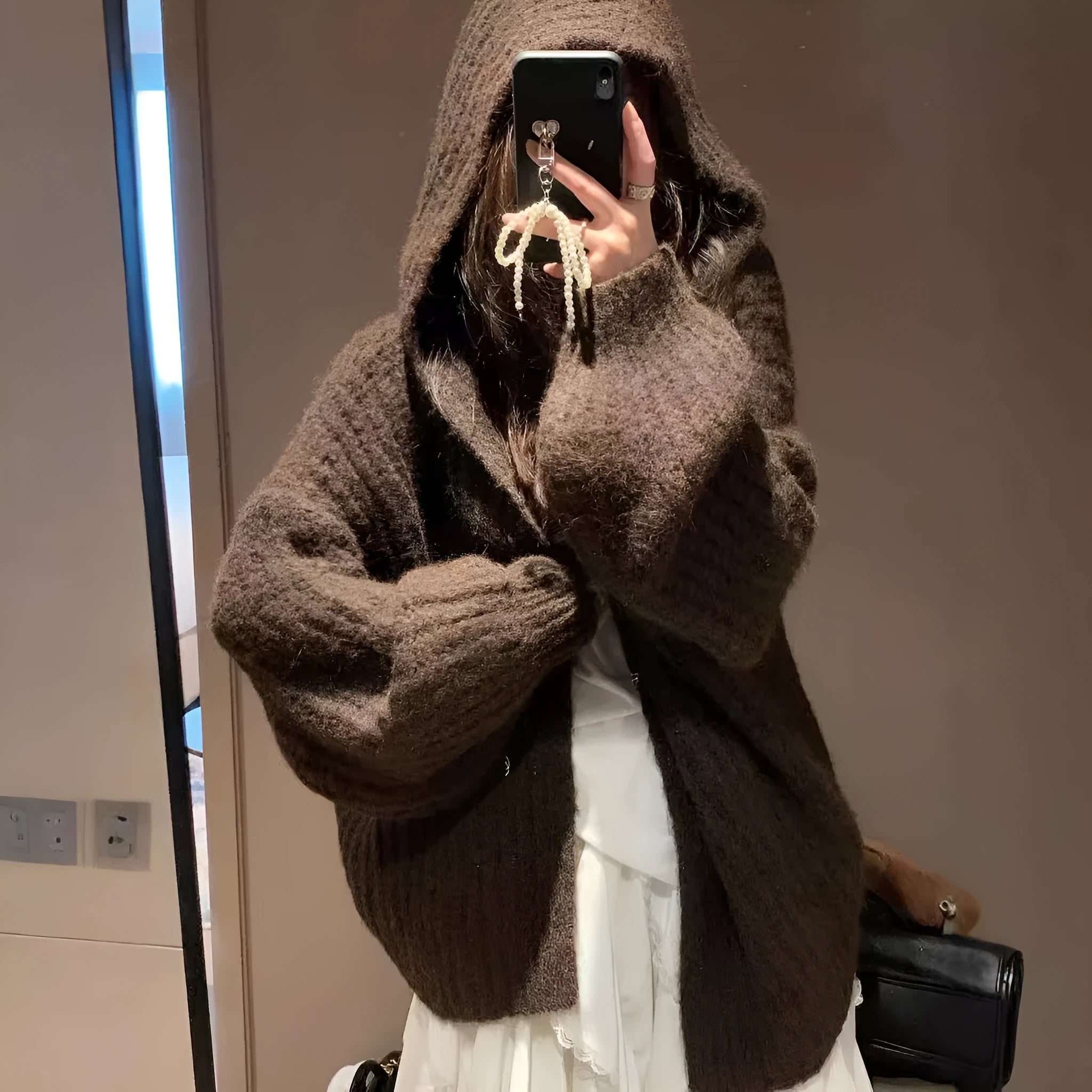 Women's dark grey loose-fit hooded cardigan sweater on a hanger