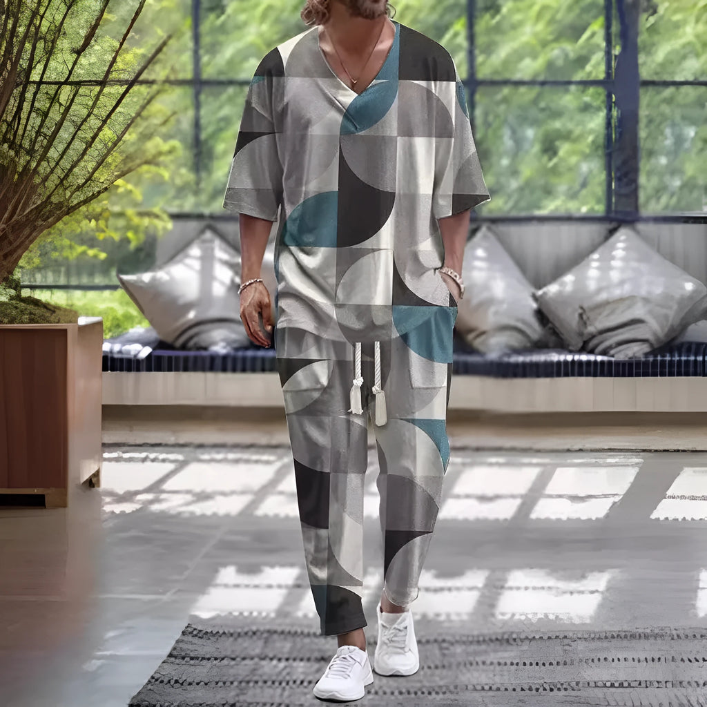 Thin polyester fibre co-ordinated suit with V-neck top, cropped sleeves, and matching trousers on a hanger.
