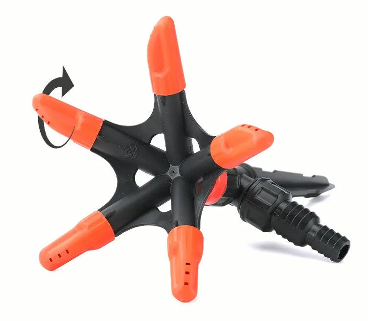 Automatic rotating garden sprinkler in orange plastic, size 14x26.5cm, on green lawn