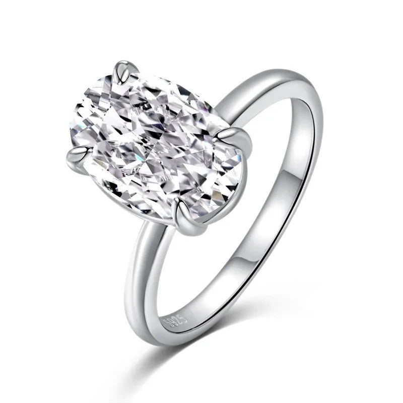 Women's oval four-claw solitaire ring with 6x9mm gemstone in gold or silver finish
