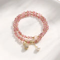 Geometric strawberry quartz crystal bracelet for women on a wrist.