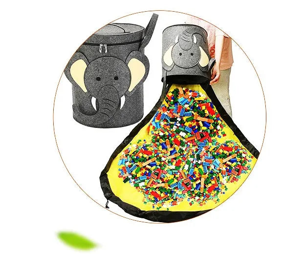 Green felt cube storage bag with pull rope, laid flat as a play mat for toys.