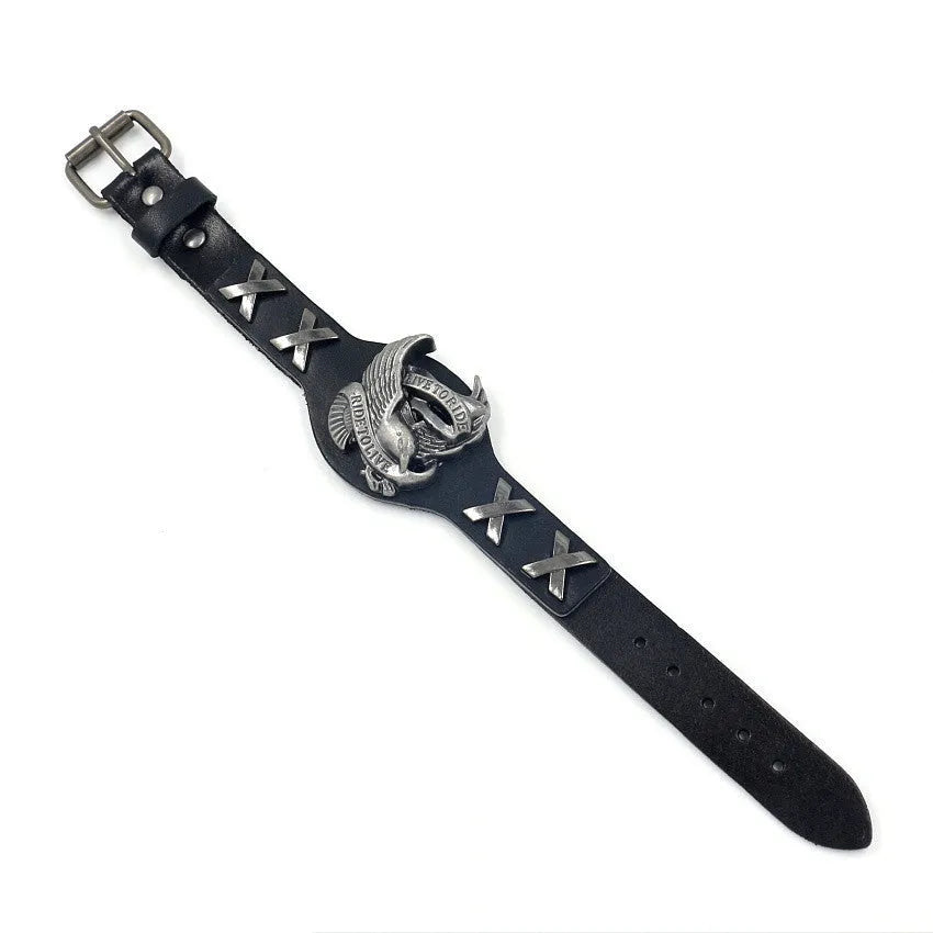 Black leather bracelet with an alloy eagle decoration and watch-button clasp on a wrist.