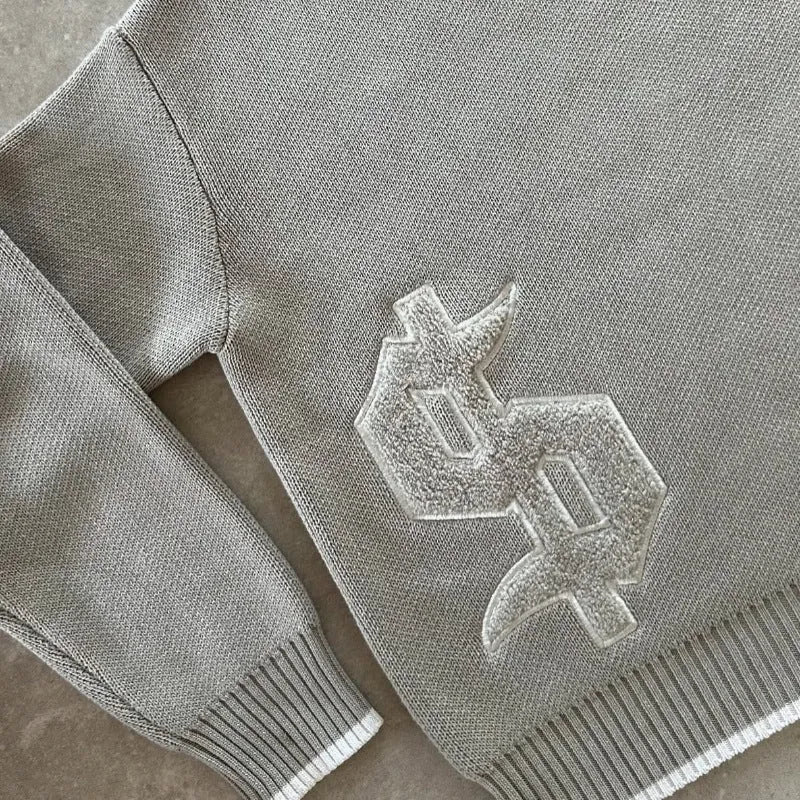 Grey loose-fitting jacquard knitwear coat with long sleeves on hanger