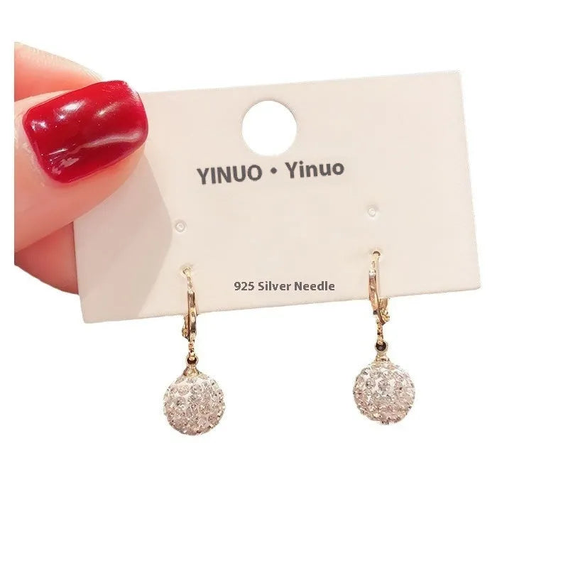 A pair of simple geometric rose-inspired earrings for women, made from electroplated copper, shown in one of the available colour types.