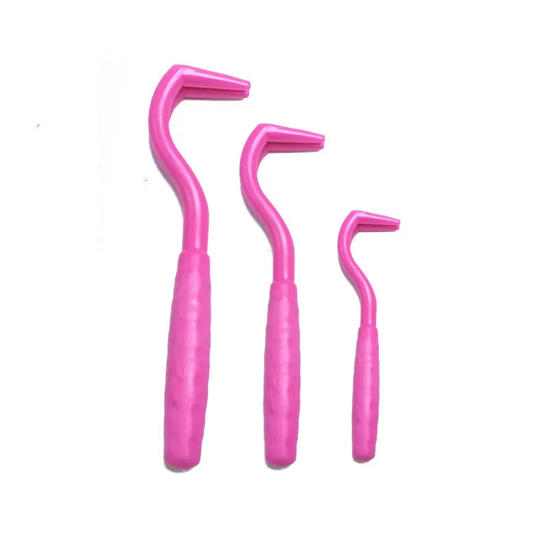 Set of three coloured plastic tick hook removal tools for dogs on a white background.
