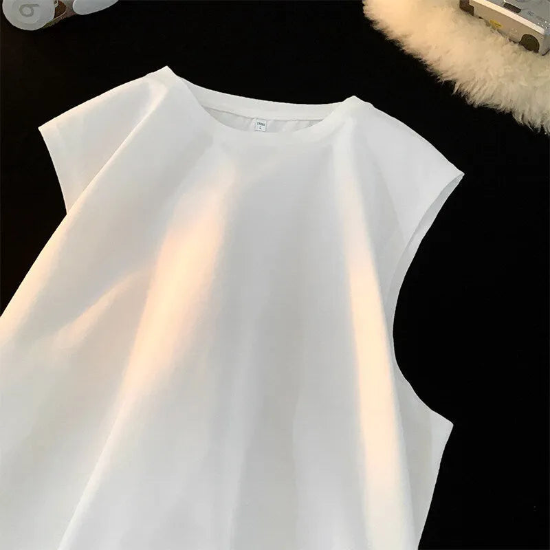 Men's loose-fitting solid colour cotton tank top on a hanger, shown in a light colour.