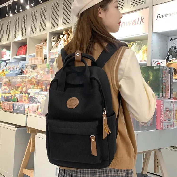 Black Oxford cloth backpack with curved shoulder straps in urban simplicity style