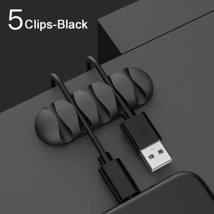 Smart cable holder with TPR flexible clips in black holding USB earphone and network cables on a desk