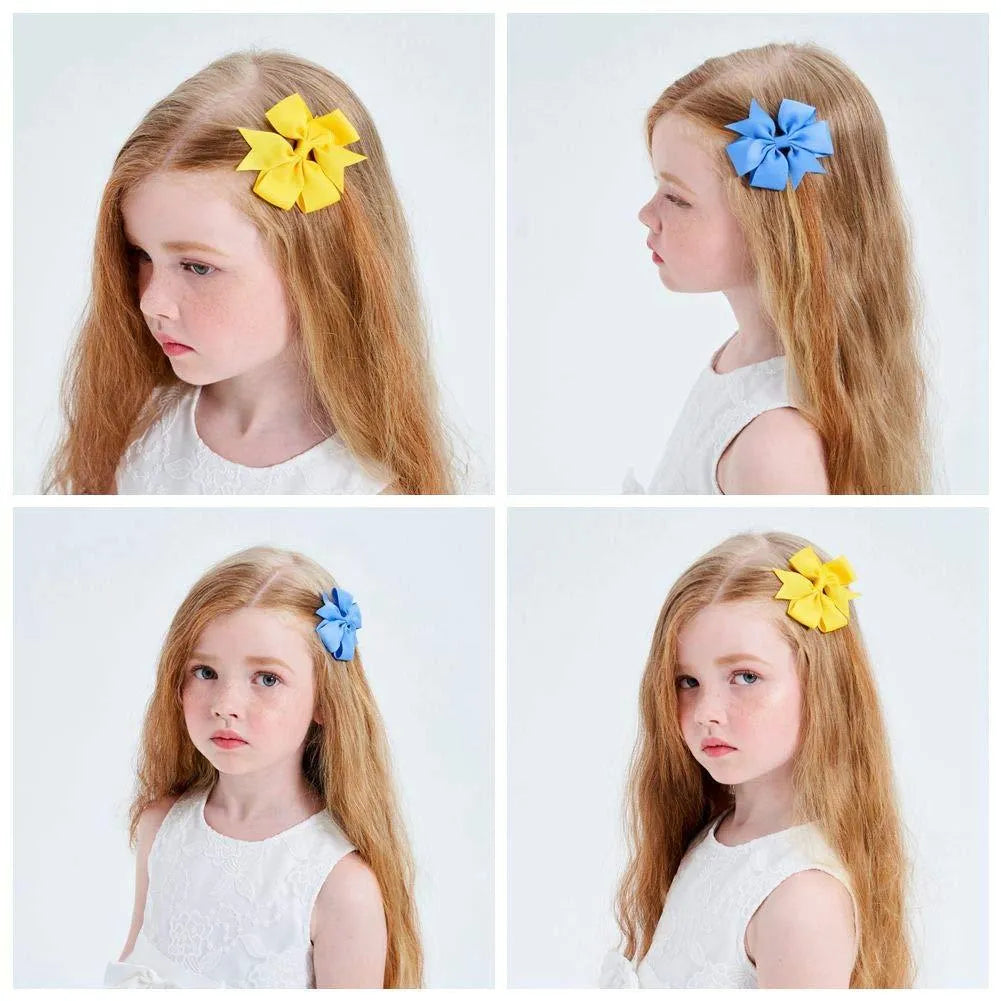 Assortment of multicoloured 3 inch grosgrain ribbon pinwheel hair bows with alligator clips for toddlers.