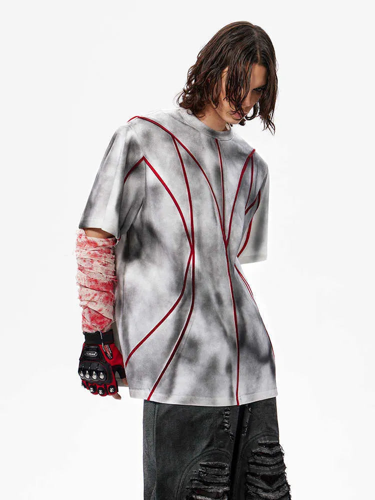 Short sleeve t-shirt with padded shoulders and raised line patchwork design on a round neck.