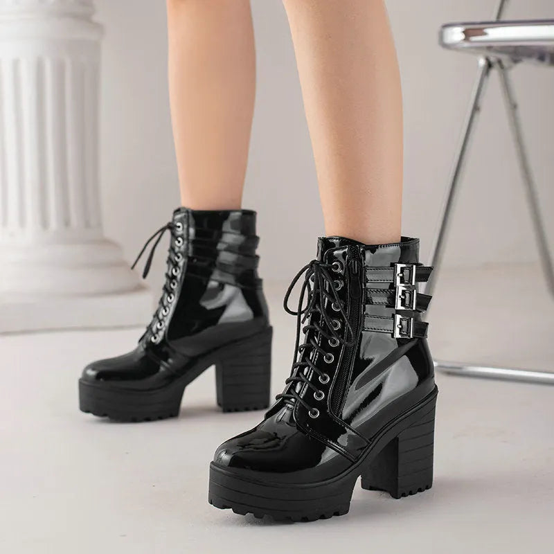 Women's black thick-heeled short boots with lace-up front and round toe on a waterproof platform.