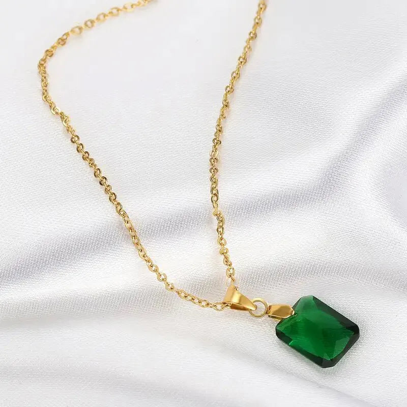 Copper geometric necklace with rectangular green pendant on an O-ring chain.