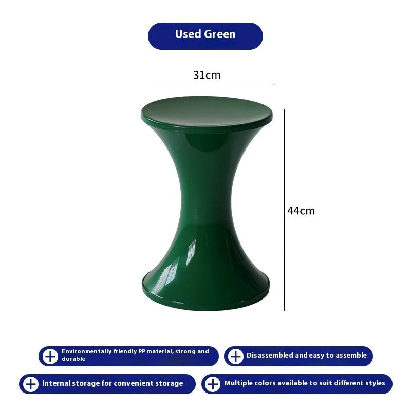 Green hourglass-shaped plastic stool for changing shoes, suitable for children and adults.