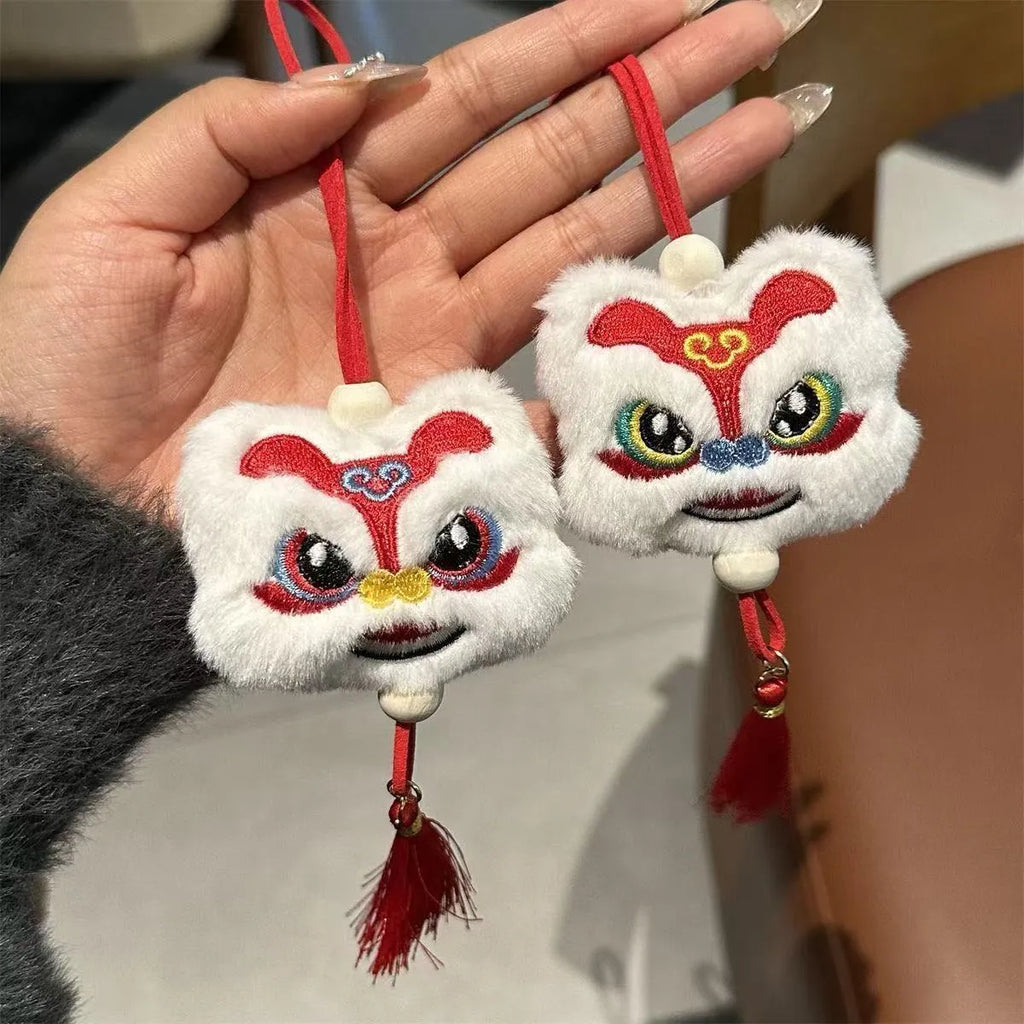 Handmade blue and yellow Chinese style plush lion keychain ornament with star stone decoration.
