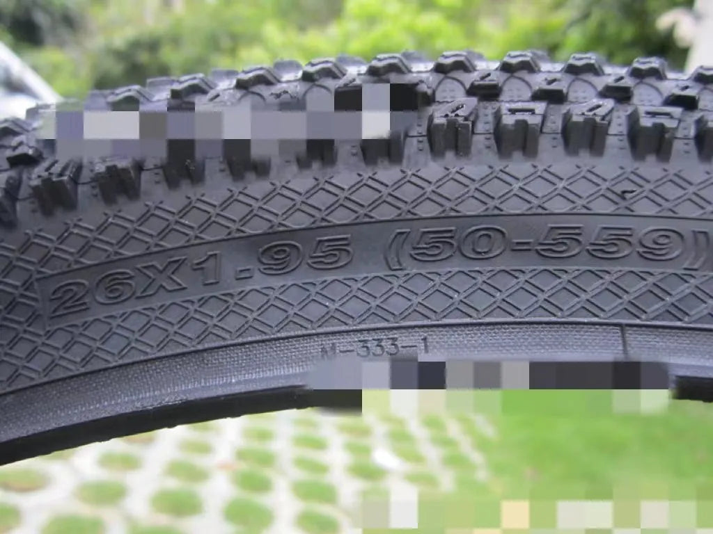 Ultralight puncture-proof mountain bike tyre shown in black with white label sidewall option.
