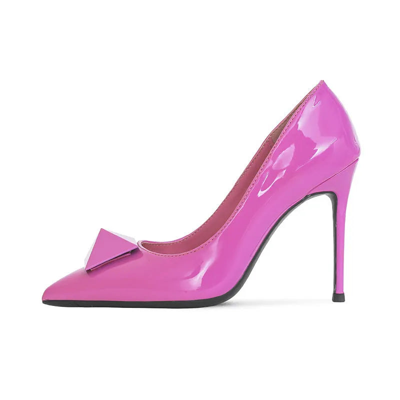Women's pink patent leather pointed toe stiletto heels with buckle closure and rivet details
