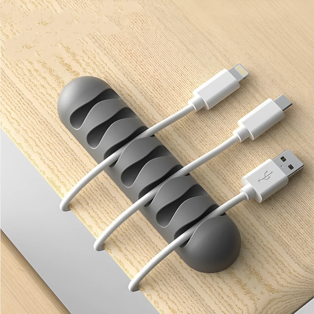 Smart cable holder with TPR flexible clips in black holding USB earphone and network cables on a desk
