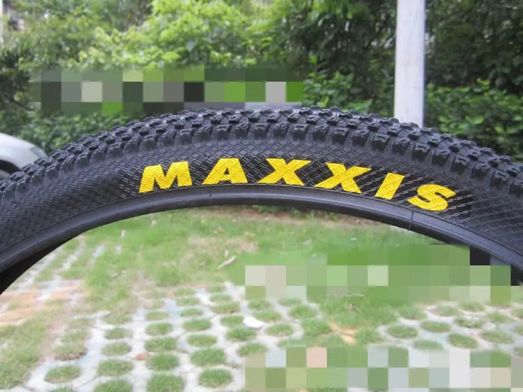 Ultralight puncture-proof mountain bike tyre shown in black with white label sidewall option.