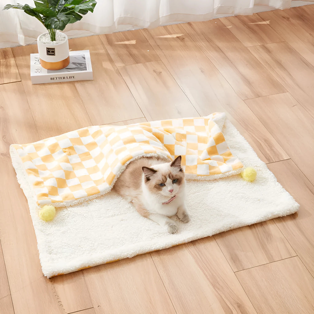 Green plaid pattern plush pet blanket for cats and dogs on a sofa