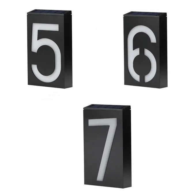 Solar powered outdoor house number light with white LEDs and wall mount.