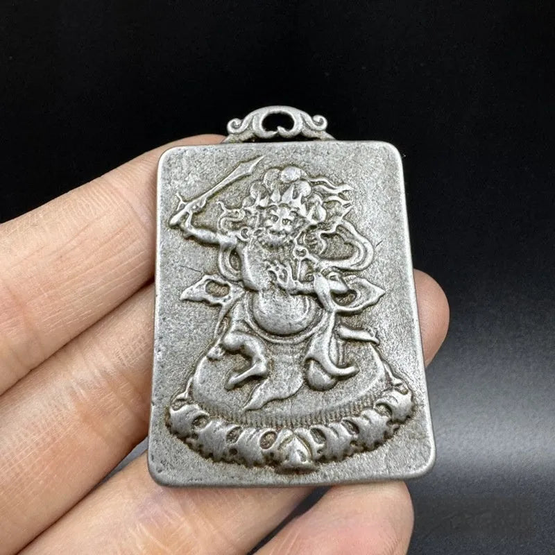 Close-up of a Chinese style iron wall pendant with geometric designs and Yamantaka figure.