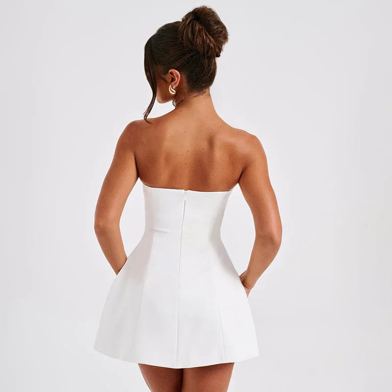 A woman wearing a solid colour backless A-line tube dress with a high waist and short skirt.