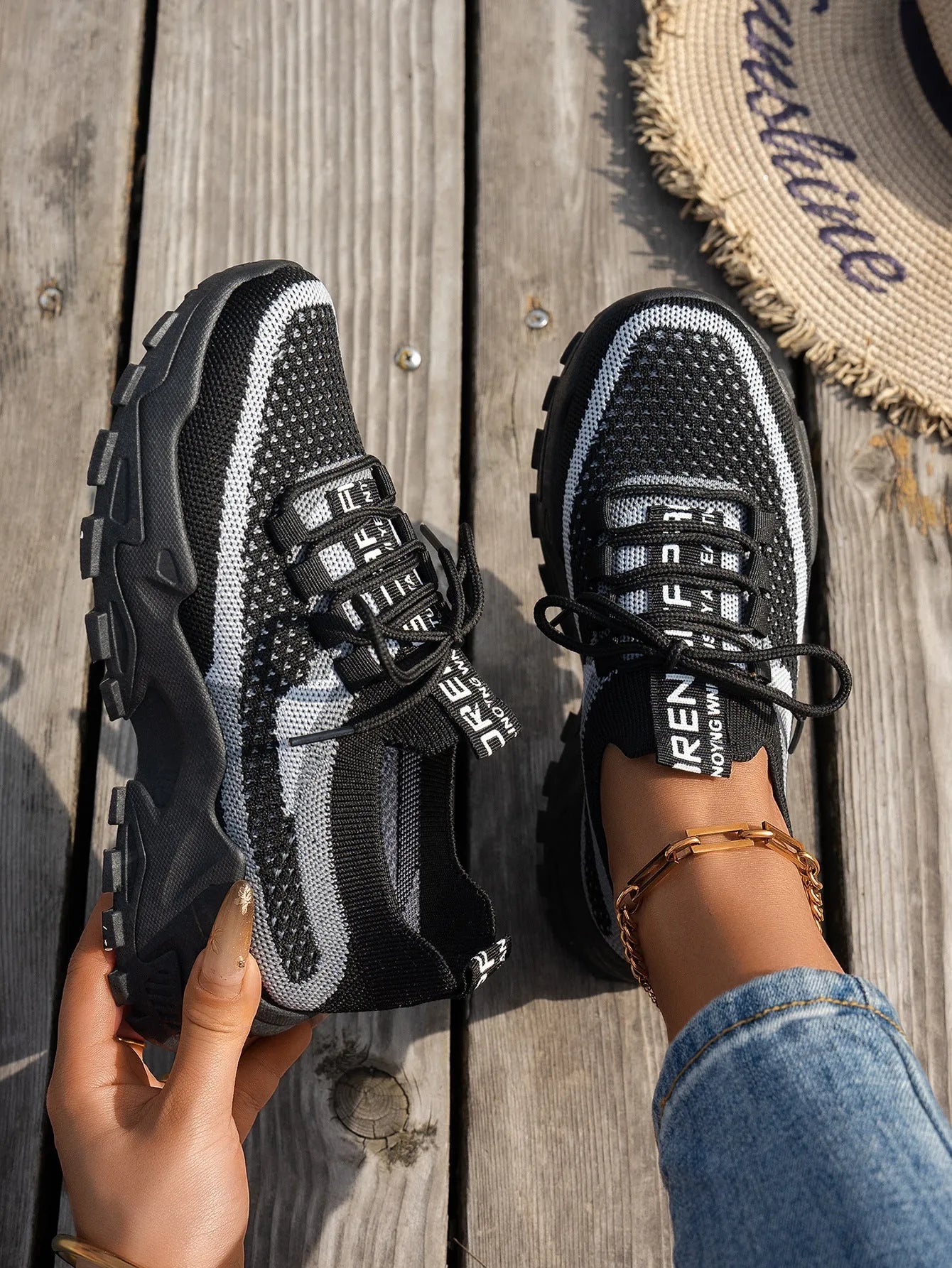 Women's lace-up Flyknit mesh sneakers in a grey colour combination with a round toe and flat rubber sole.