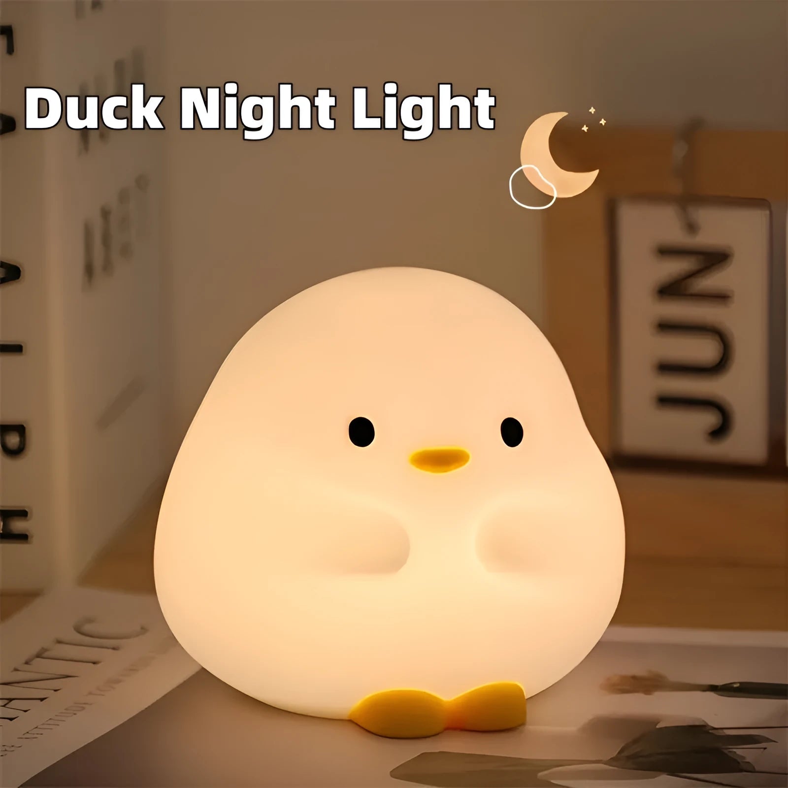 Cute duck-shaped silicone LED night lamp on a bedside table with warm light