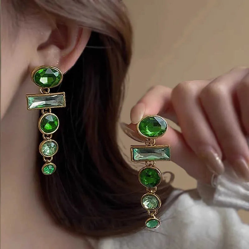 A pair of geometric Chinese style alloy earrings with a retro green gradient finish and zircon-inlaid tassels.