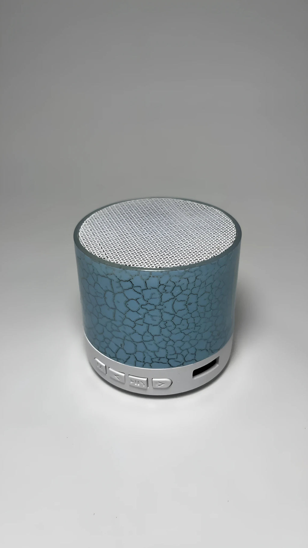 A9 Mini Cracked Bluetooth Speaker in blue with LED lights on a table