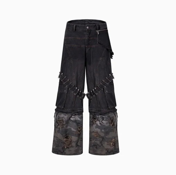 Grey men's jeans with camouflage pattern and spliced construction, showing pin and ribbon details.