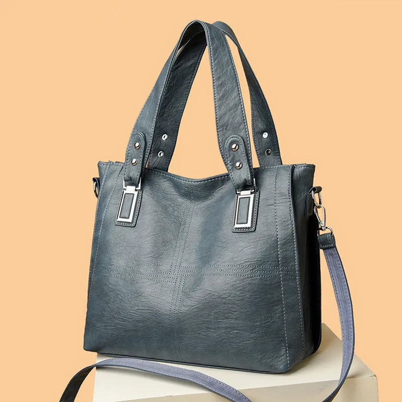 Women's soft PU handbag in horizontal square shape with sewing thread detail and single shoulder strap.