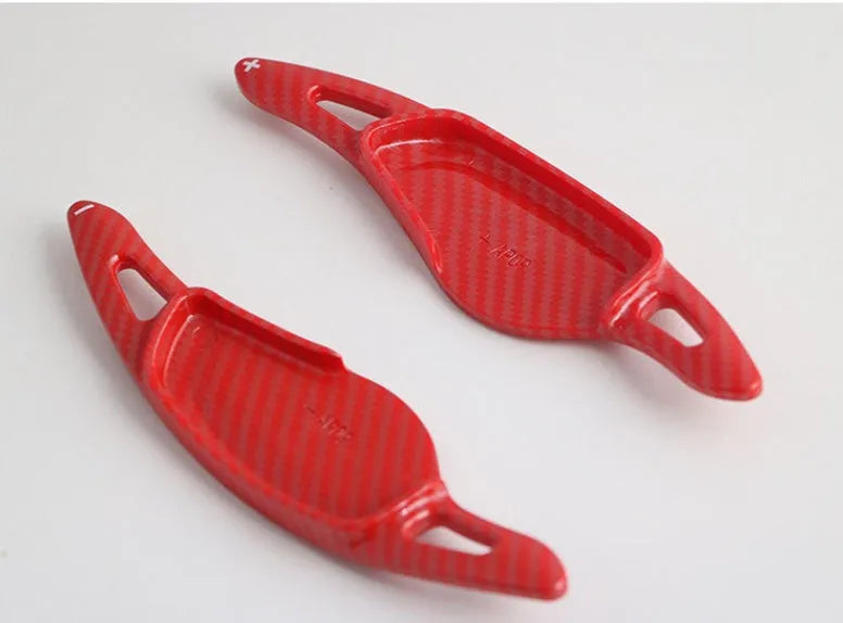 Carbon fibre pattern steering wheel paddle shifters in black and red finishes
