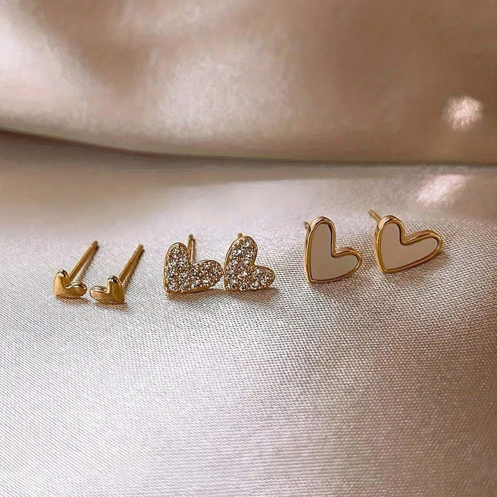 Women's heart-shaped earring set with three pairs in gold, black, black and white, and pink electroplated colours