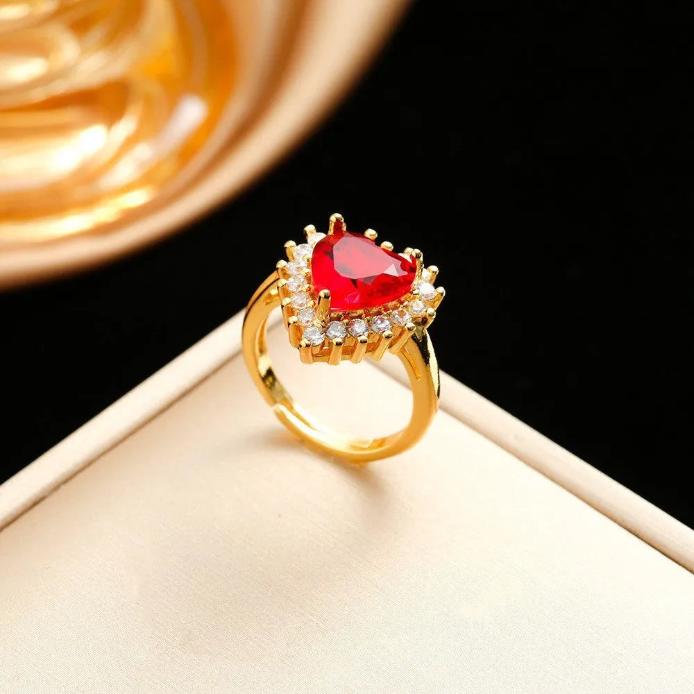 Gold red titanium steel necklace, earrings, and ring set with heart flower pendants and gem inlays.