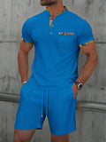 Men's grey waffle zipper polo collar short sleeve top and matching shorts laid flat