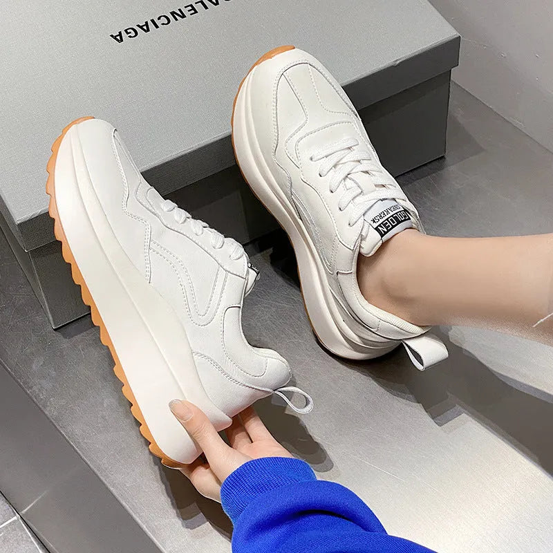 Beige women's leather casual sports shoes with low top, round toe, lace-up closure, and cross strap detail