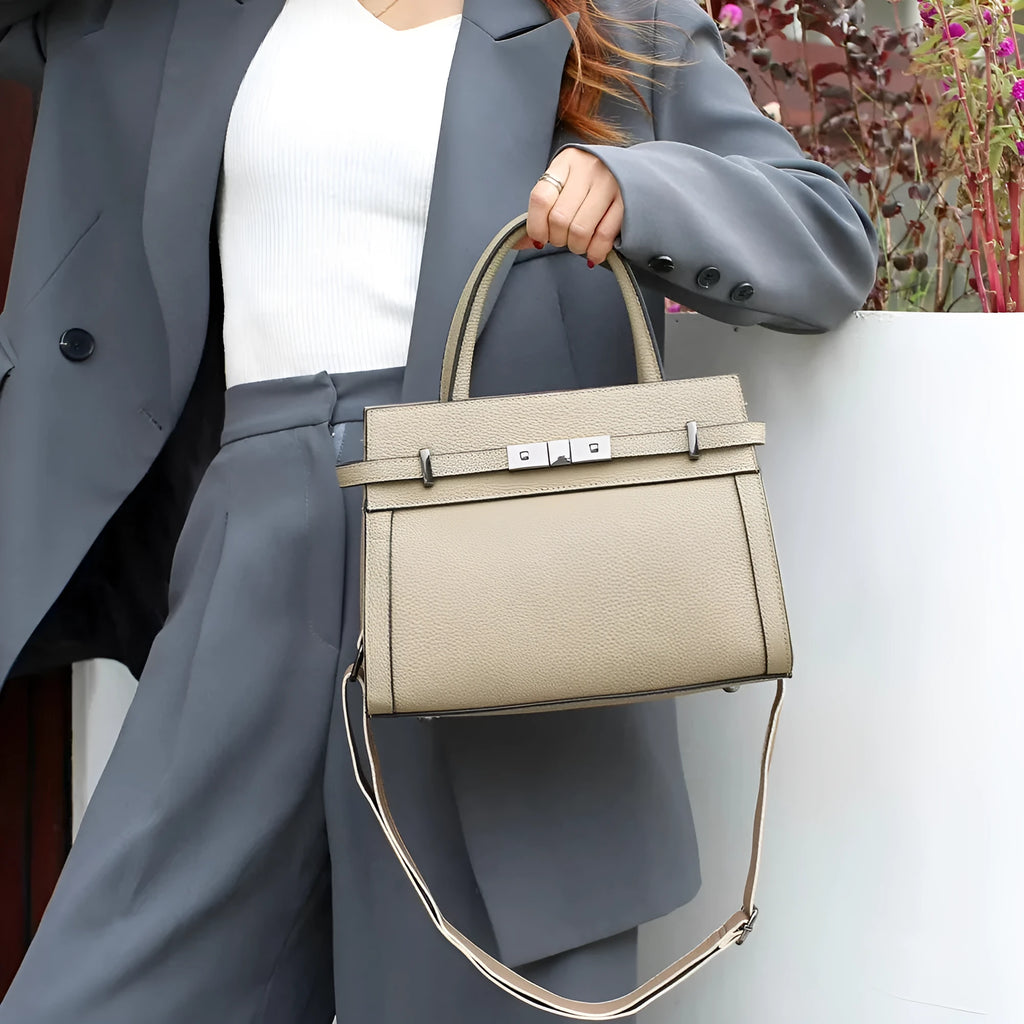 Genuine leather small square shoulder bag in almond green showing external pocket and stitching detail.