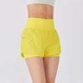 Women's loose fit cotton blend fitness shorts in lemon yellow colour on a hanger