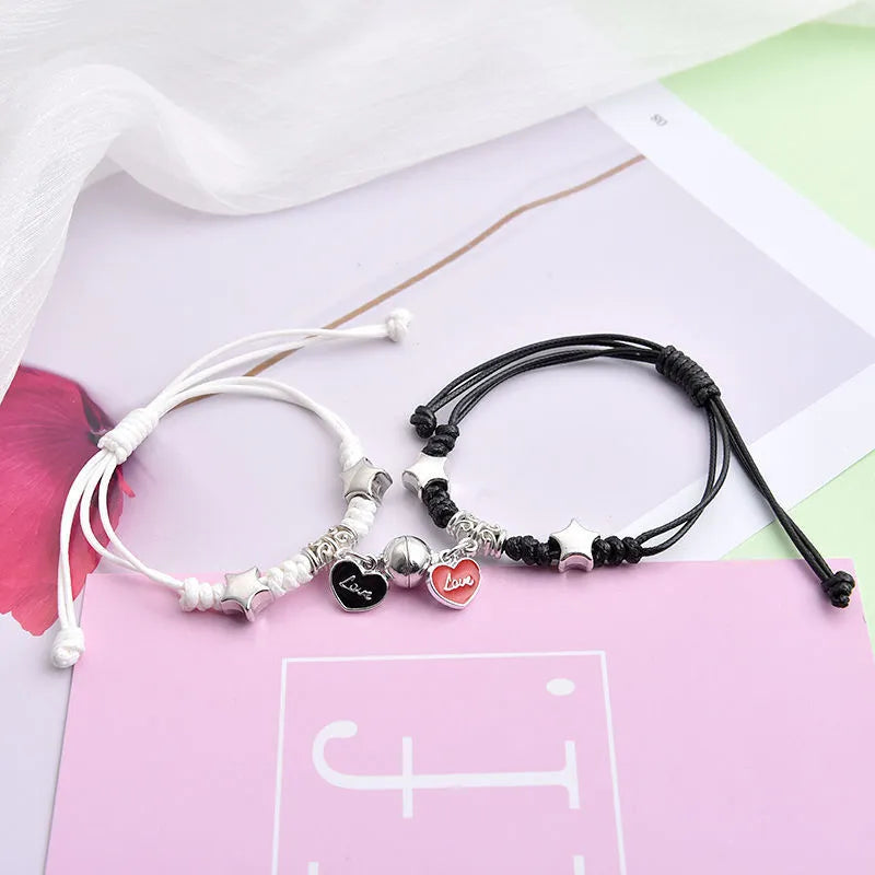 Magnetic clasp couple bracelets with alloy construction and symbolic designs including crown and love lock motifs.