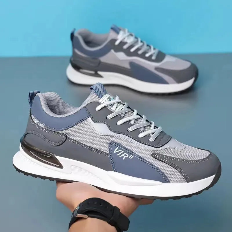 Men's colour block mesh sneakers in black, grey, and white with round toe and flat heel.
