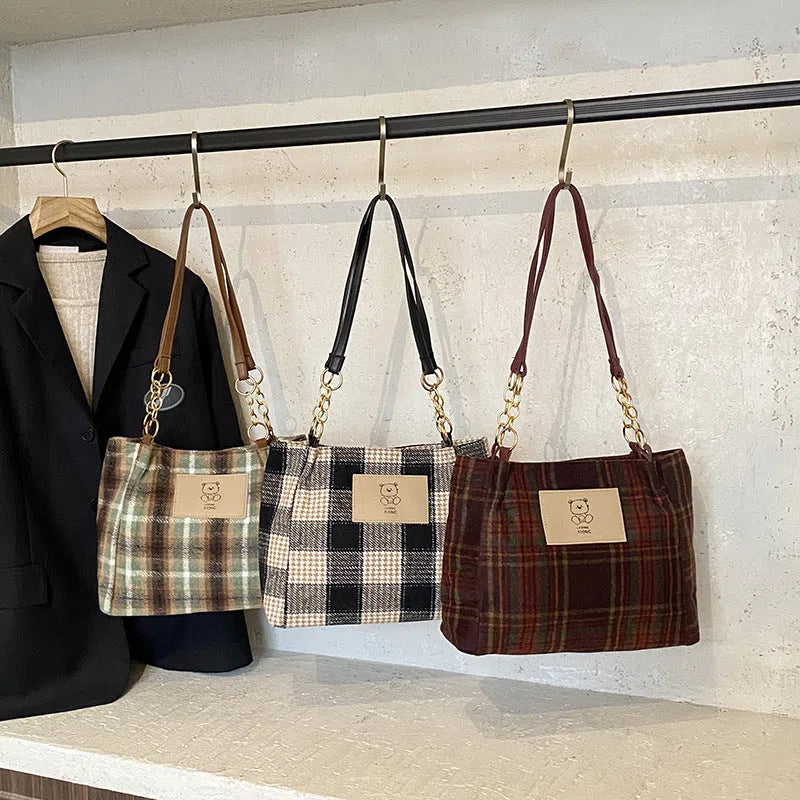 Wool plaid women's single-shoulder commuter bag in brown with stitched seam detailing and double straps
