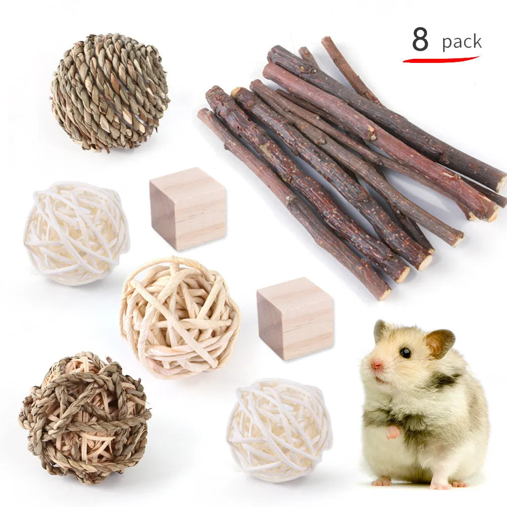 Assortment of natural wooden and woven chew toys for small pets like rabbits and parrots.