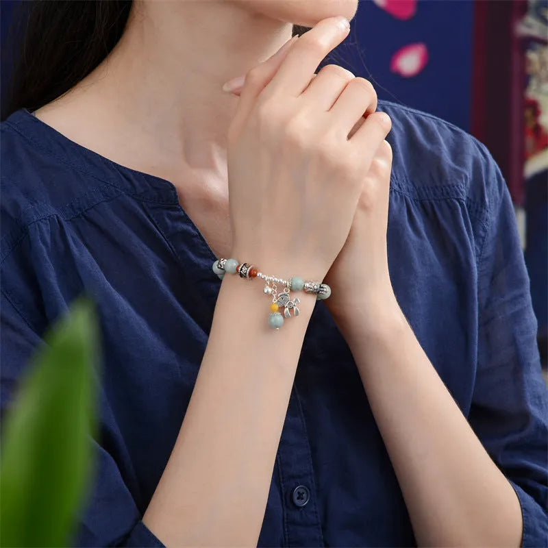 Natural emerald green vintage bracelet with jade stones on an alloy band, showing retro hand-crafted design.