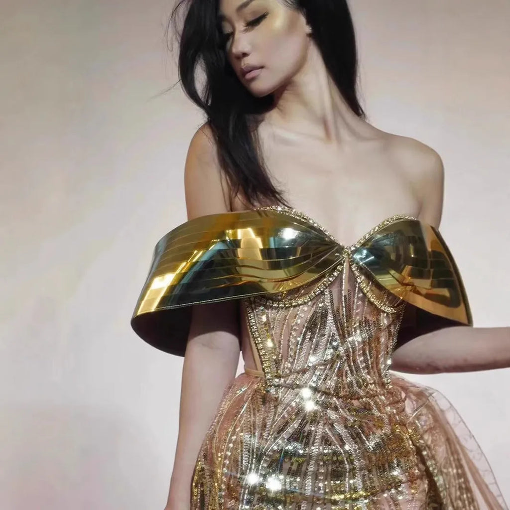Gold sequined strapless long dress with a tulle skirt and high side slit.