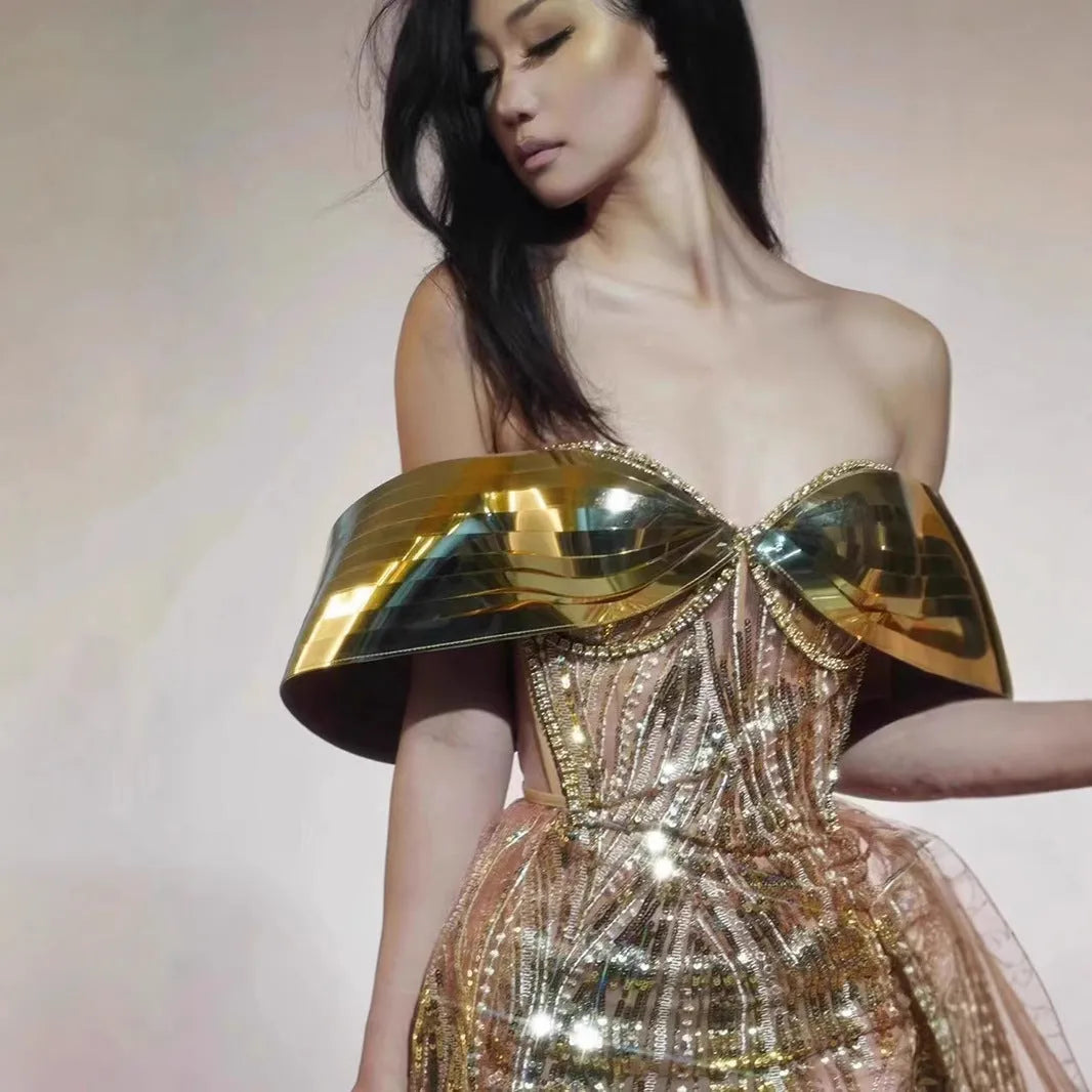 Gold sequined strapless long dress with a tulle skirt and high side slit.