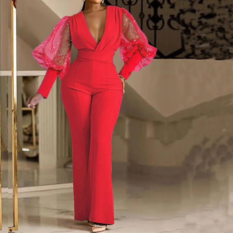 Red mesh stitch long sleeve jumpsuit with elastic waist and wide leg trousers on a hanger.