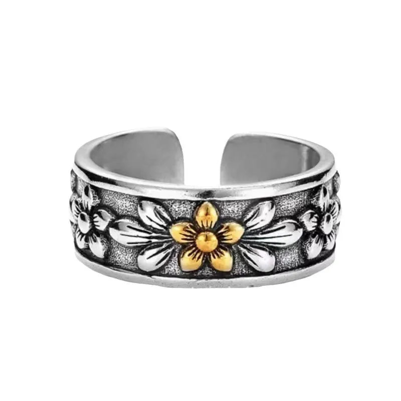 Vintage antique silver gold flower open ring with camellia floral design on a neutral background